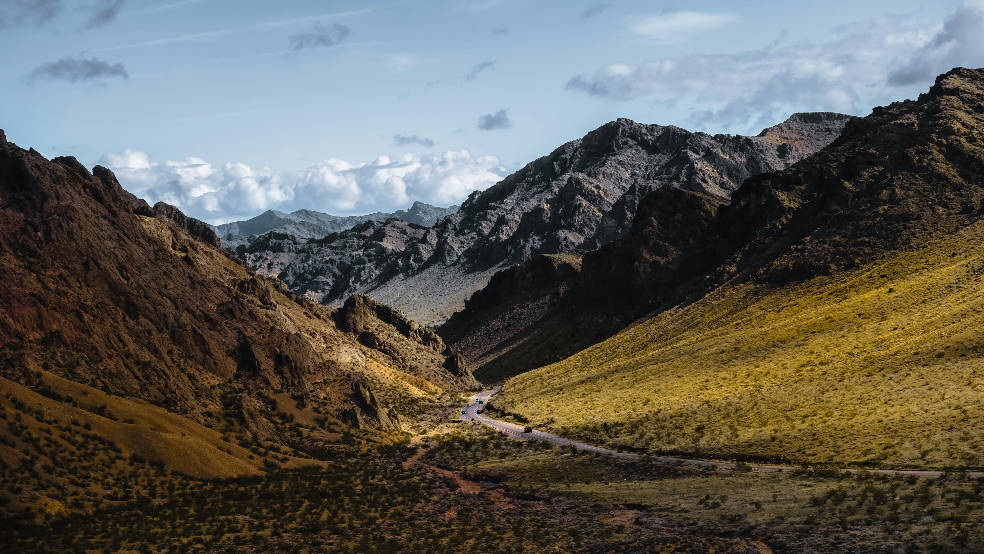 A scenic view of a valley with mountains in the background